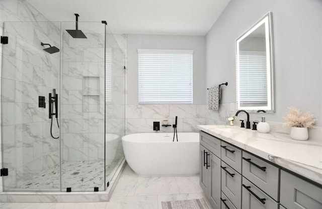 bathroom featuring vanity, shower with separate bathtub, and tile walls