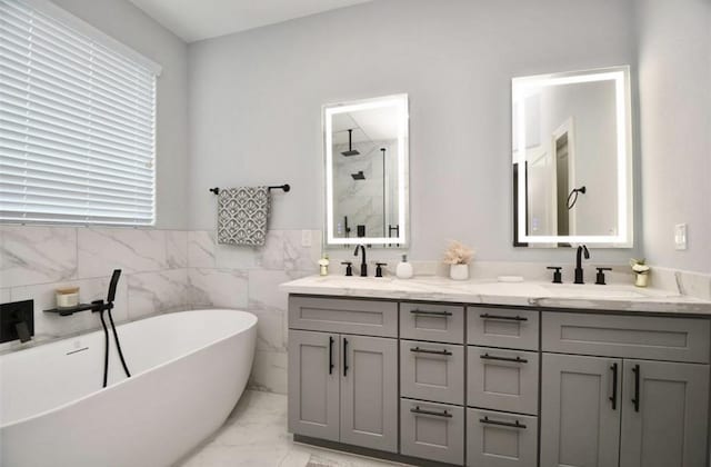 bathroom featuring vanity, independent shower and bath, and tile walls