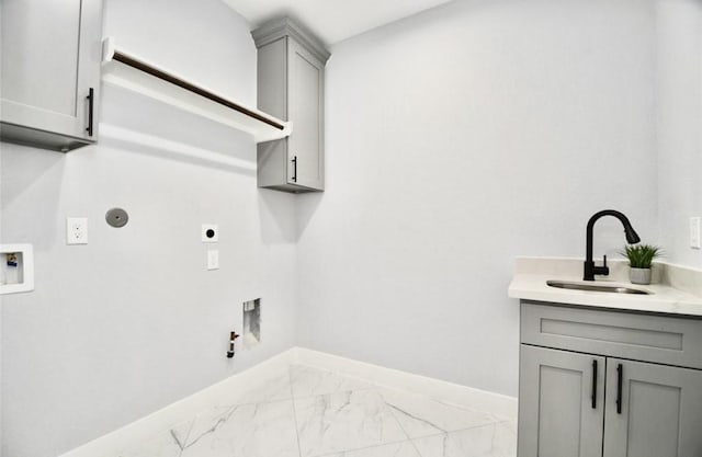 clothes washing area with hookup for an electric dryer, washer hookup, cabinets, sink, and hookup for a gas dryer