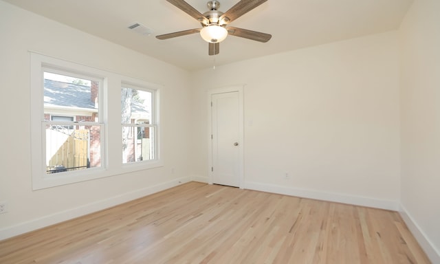 empty room with ceiling fan and light wood-type flooring