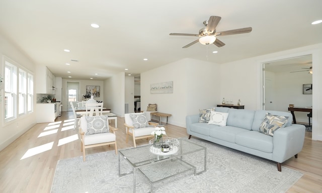 living room featuring ceiling fan and light wood-type flooring