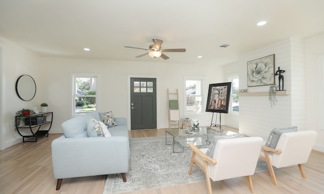 living room featuring ceiling fan and light hardwood / wood-style flooring