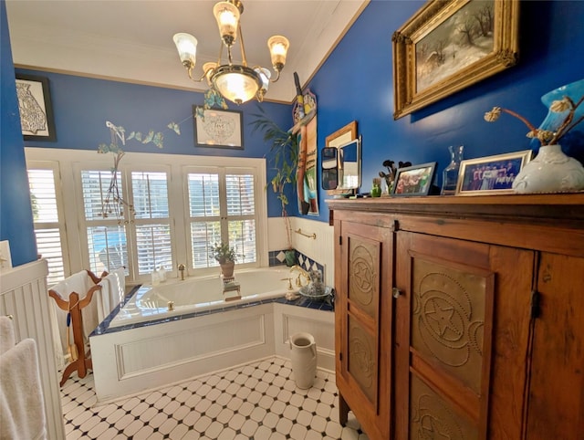 bathroom with tile patterned floors, a bathtub, crown molding, and an inviting chandelier