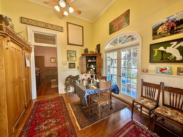 dining room featuring dark hardwood / wood-style floors, ceiling fan, ornamental molding, and french doors