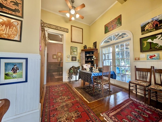 dining space featuring ceiling fan, french doors, wood-type flooring, and ornamental molding