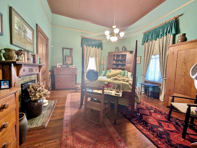 bedroom featuring a notable chandelier, dark hardwood / wood-style flooring, and multiple windows