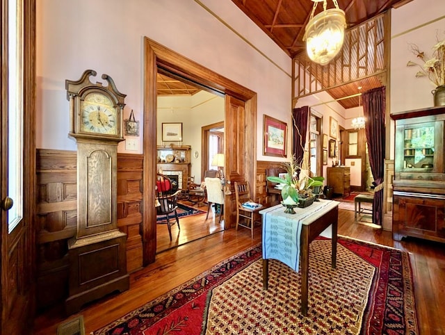 interior space featuring wooden walls, wood ceiling, and hardwood / wood-style flooring