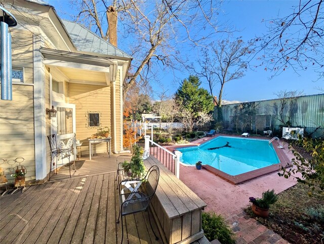 view of swimming pool featuring a wooden deck