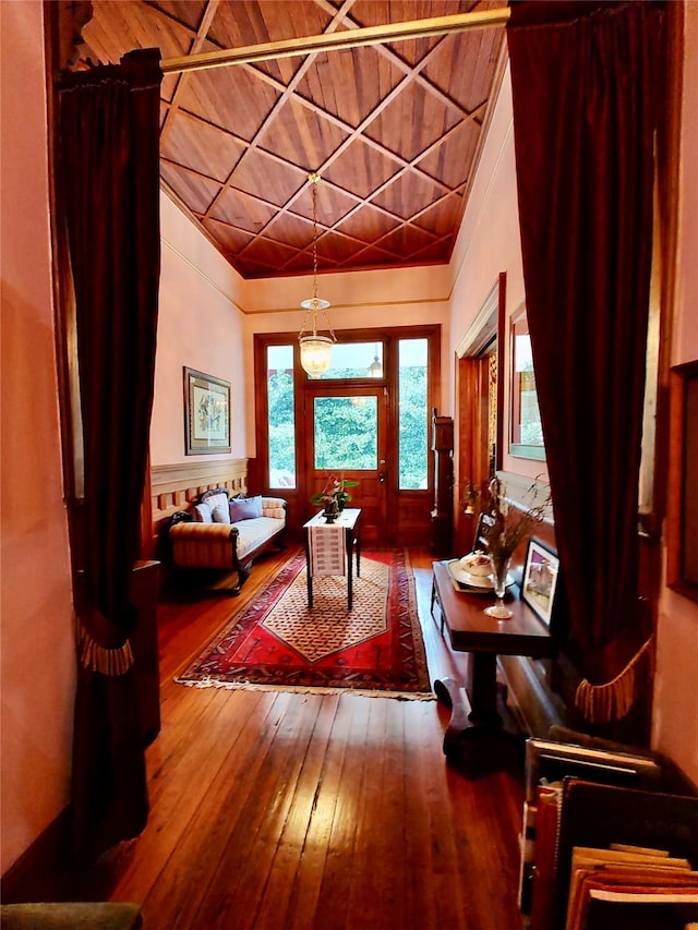 interior space featuring wood-type flooring, wooden ceiling, and vaulted ceiling