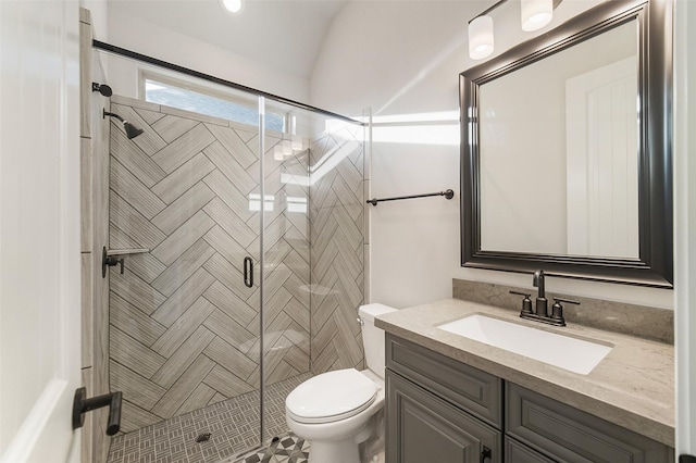 bathroom with a shower with door, vanity, and toilet