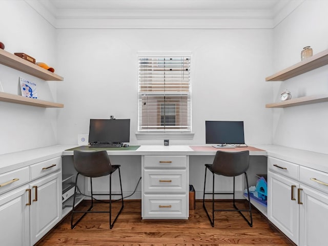 office area with built in desk and hardwood / wood-style flooring