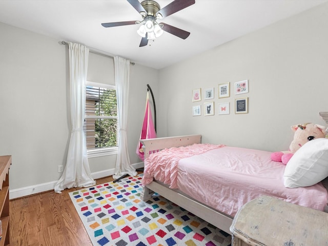 bedroom with hardwood / wood-style flooring and ceiling fan