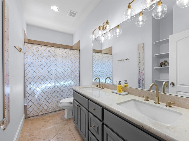 bathroom with tile patterned flooring, vanity, and toilet