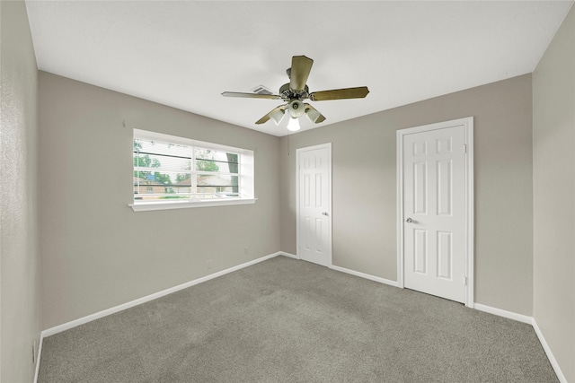 unfurnished bedroom featuring ceiling fan and carpet floors