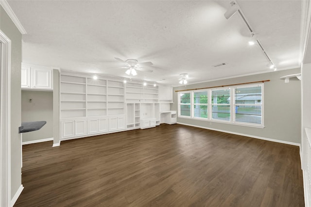 unfurnished living room with built in shelves, a textured ceiling, ceiling fan, crown molding, and dark wood-type flooring