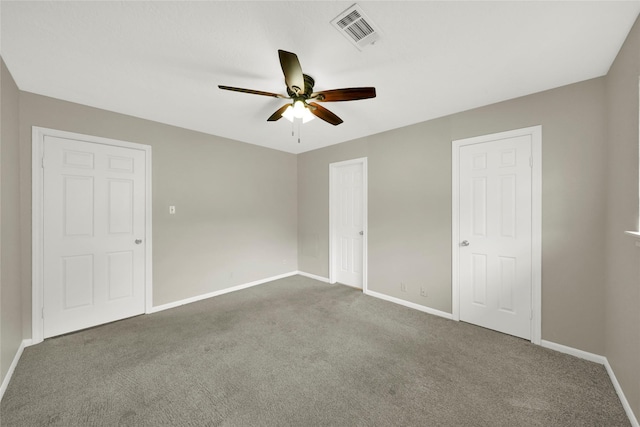 unfurnished bedroom featuring ceiling fan and carpet floors