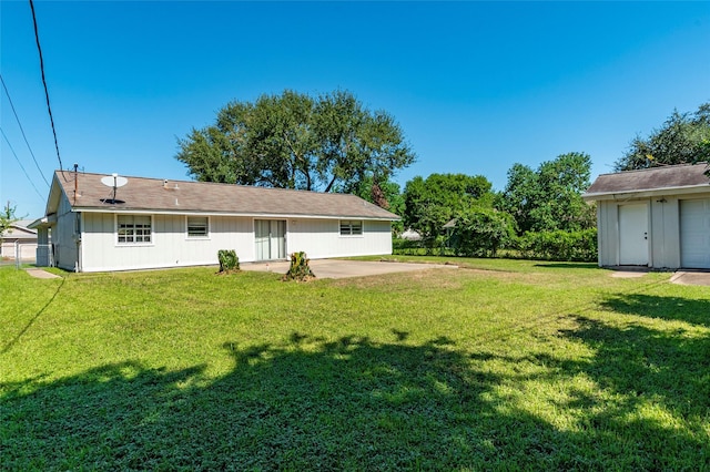 back of house with a lawn and a patio