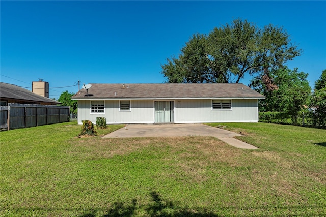 rear view of house with a yard and a patio