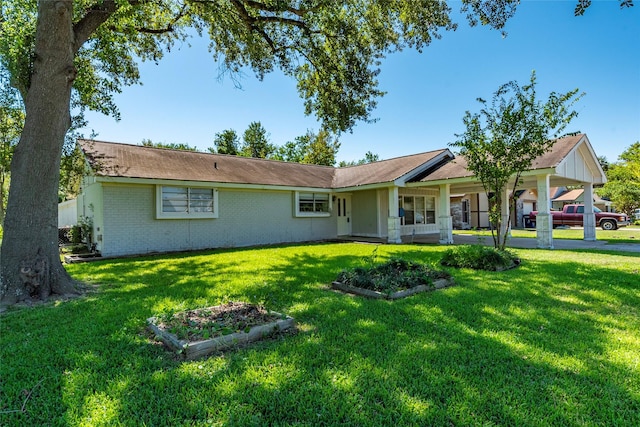 rear view of house featuring a yard and covered porch