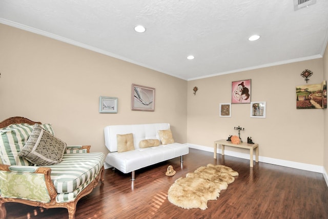 sitting room featuring crown molding and dark hardwood / wood-style floors