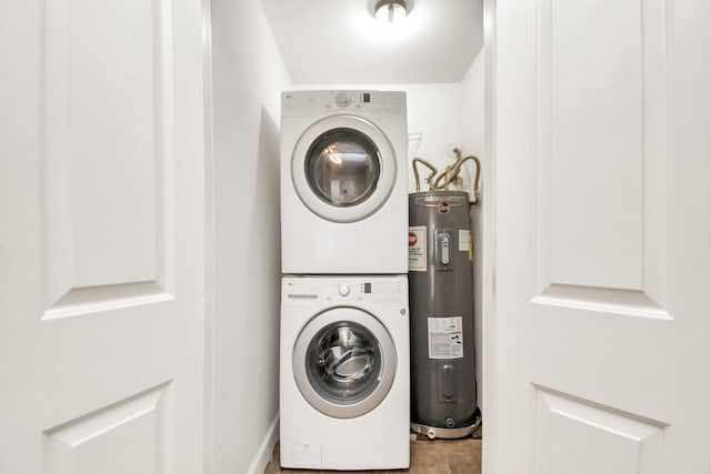 laundry room with water heater and stacked washer and clothes dryer