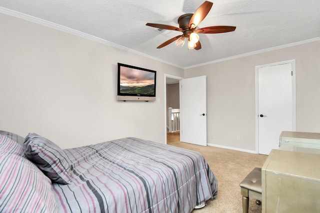 carpeted bedroom featuring ceiling fan and crown molding