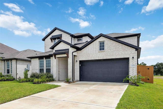 view of front of property with a front yard and a garage