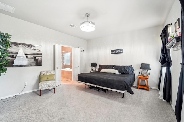 carpeted bedroom featuring ensuite bath