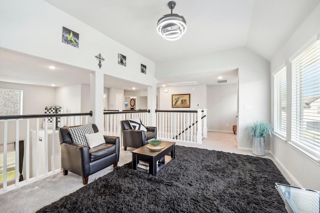 living area featuring light carpet and lofted ceiling