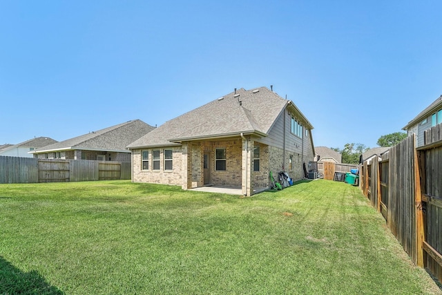 back of house featuring a yard and a patio area