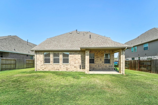 back of property featuring a yard and a patio