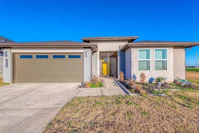 prairie-style home with an attached garage, brick siding, driveway, and stucco siding