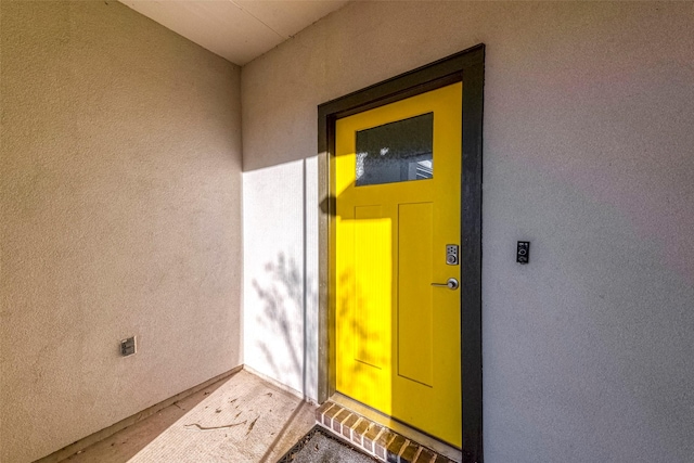 property entrance with stucco siding