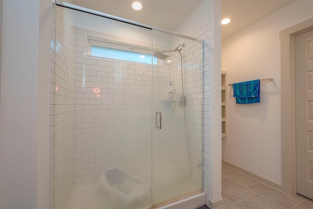 bathroom featuring tile patterned flooring, recessed lighting, and a shower stall