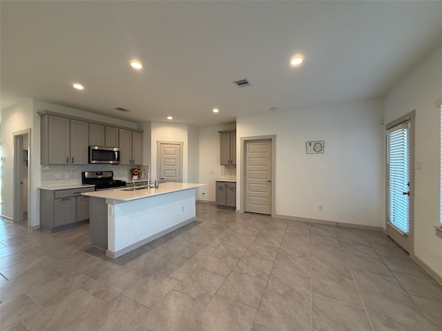 kitchen featuring visible vents, recessed lighting, gray cabinets, stainless steel appliances, and light countertops