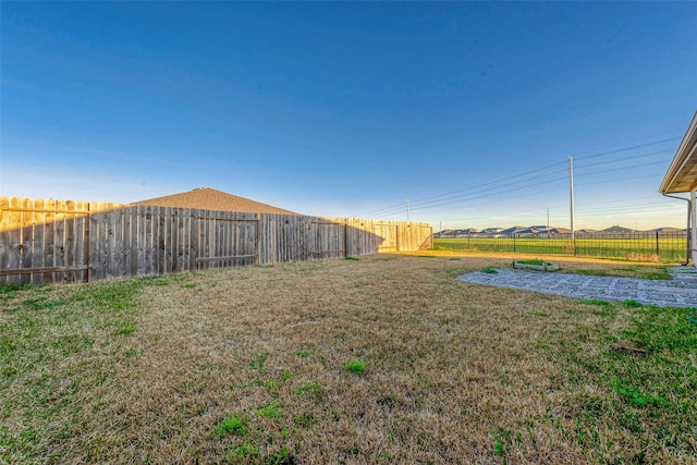 view of yard with a fenced backyard