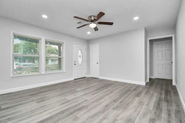 entryway featuring ceiling fan and light hardwood / wood-style floors