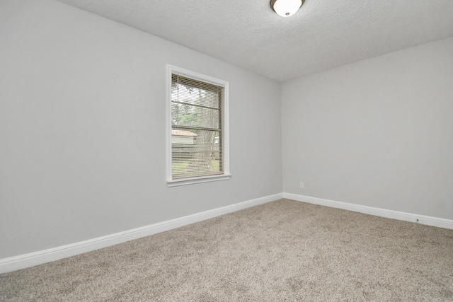 carpeted spare room featuring a textured ceiling