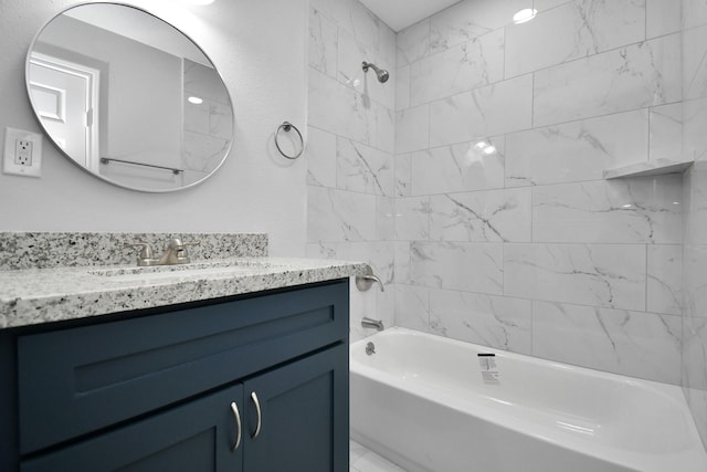 bathroom with vanity and tiled shower / bath