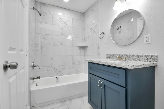 bathroom with vanity and tiled shower / bath combo