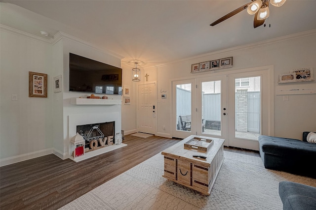 living room with hardwood / wood-style flooring, ceiling fan, ornamental molding, and french doors