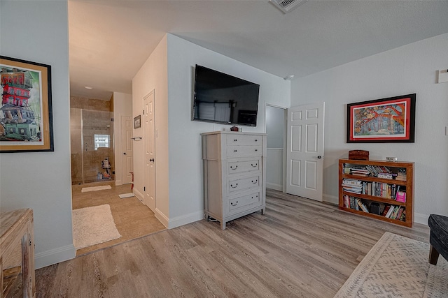 interior space featuring ensuite bathroom and light wood-type flooring