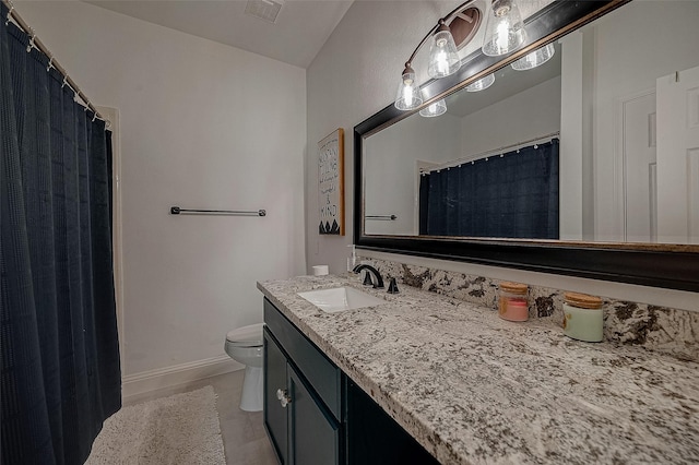 bathroom with tile patterned floors, vanity, and toilet