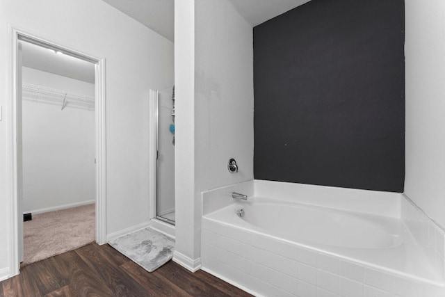 bathroom featuring hardwood / wood-style floors and independent shower and bath