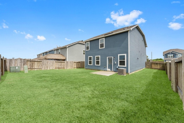 back of house featuring a patio, cooling unit, and a lawn