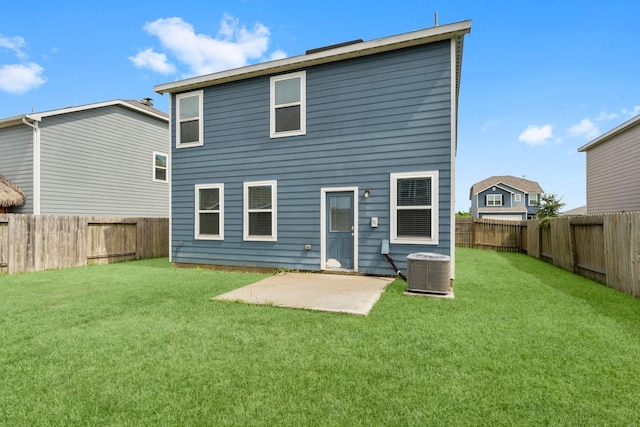 back of property with central air condition unit, a patio area, and a lawn