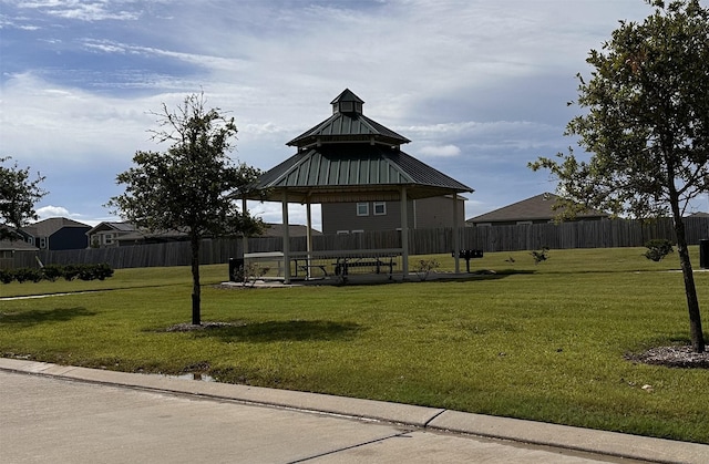 view of property's community with a gazebo and a yard