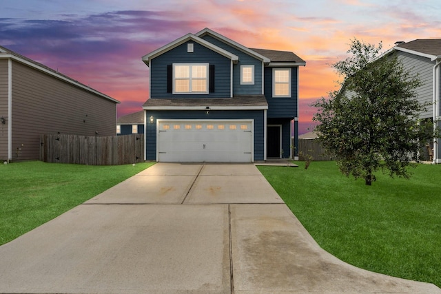 front facade with a yard and a garage