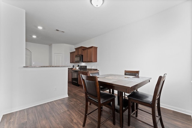 dining room with dark hardwood / wood-style flooring