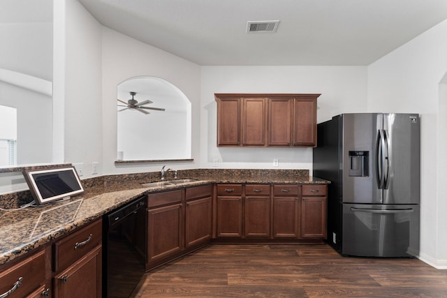 kitchen with dark wood-type flooring, sink, ceiling fan, black dishwasher, and stainless steel fridge with ice dispenser